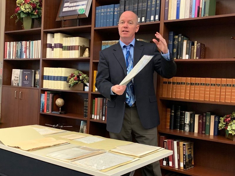 Editor and historian Alex D. Smith exhibiting some of the documents featured in Documents, Volume 9 of the Joseph Smith Papers.