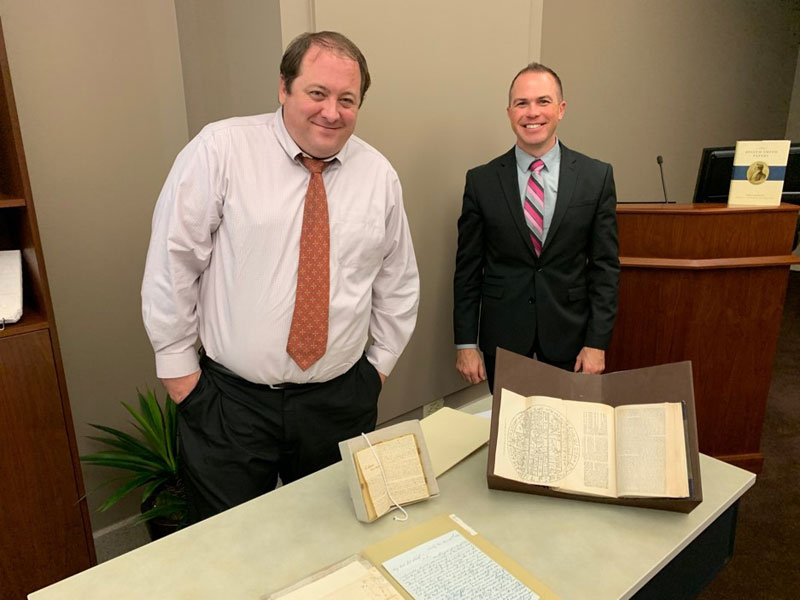 Editors and historians Christian K. Heimburger, right, and Christopher James Blythe, left, exhibiting some of the documents featured in Documents, Volume 9 of the Joseph Smith Papers.