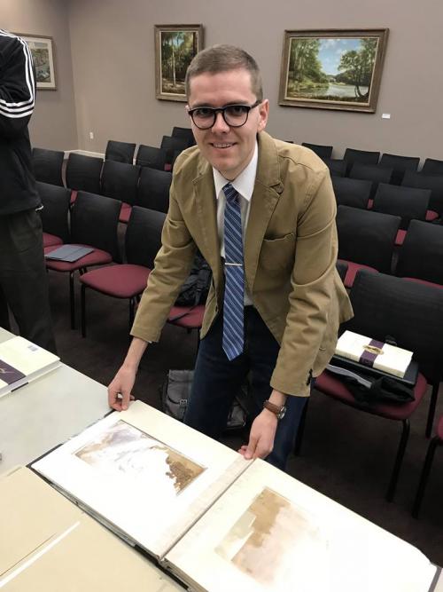 Book of Mormon Central research associate Stephen O. Smoot poses with Joseph Smith’s Egyptian papyri.