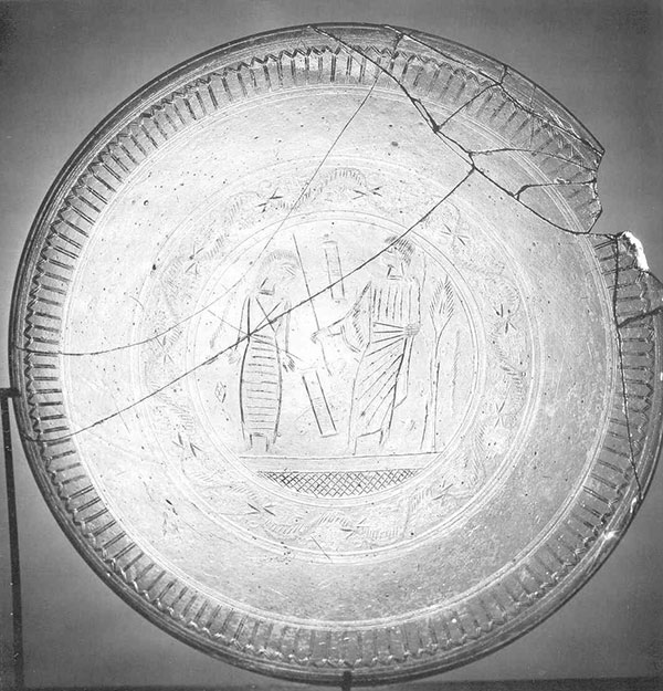 A clear glass plate with etching of Jesus raising Lazarus. Photo by John W. Welch.