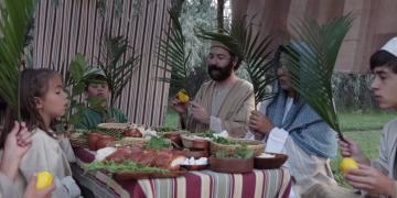 Israelite family in their booth during Sukkot.